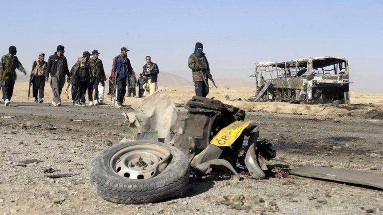 Pakistani security personnel cordon off the site of a car bomb attack on Shiite pilgrims buses in Mastung