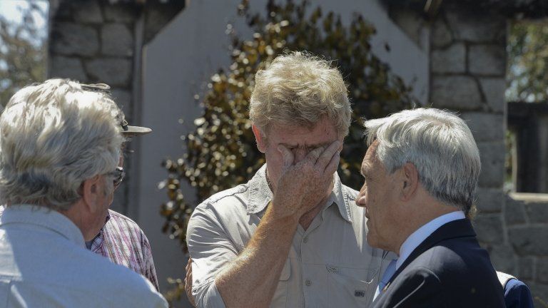 President Sebastian Pinera (r) speaks to friends and relatives of the Luchsingers