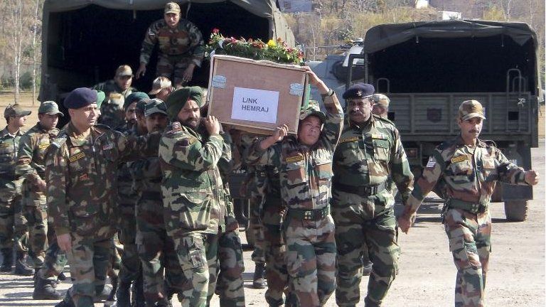 Indian soldiers carry coffin reported to contain body of colleague killed by Pakistani soldiers (9 January)