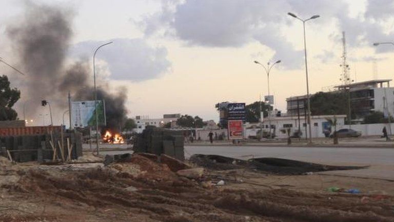 Police car burns after clashes in Benghazi in December 2012