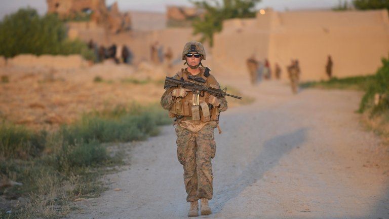 US Marine Cpl Michelle Berglin patrols in Sangin, Afghanistan, on 10 June 2012
