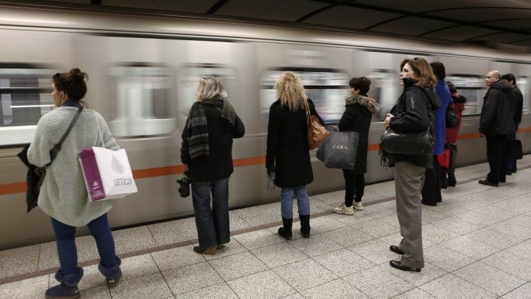 Passengers wait to board on a train at Syntagma metro station after the end of a nine-day strike in Athens, 25 January 2013