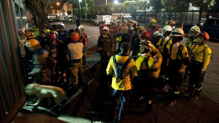 Rescue workers prepare to search for victims at the headquarters of state-owned Mexican oil giant Pemex in Mexico City late on 31 January 2013