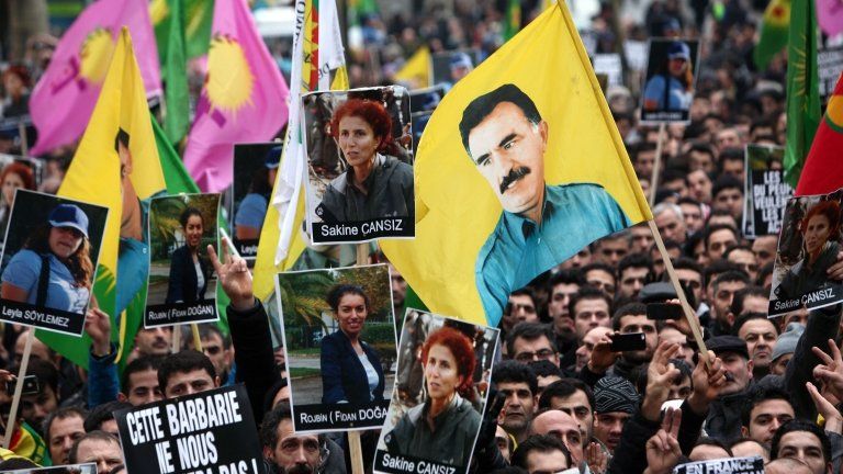 Demonstrators of Kurdish origin gathering with flags displaying PKK (Kurdistan Workers Party) leader Abdullah Ocalan to protest after the killing of three Kurdish women activists Thursday in the French capital, in Paris, 12 January 2013