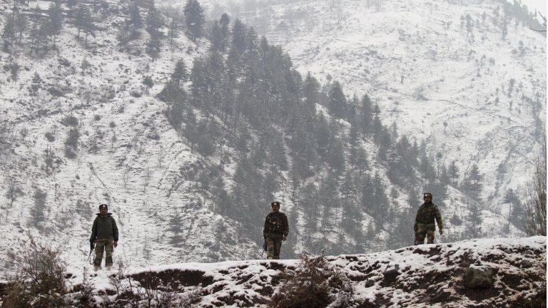 Indian army soldiers patrol near the Line of Control (LOC), the line that divides Kashmir between India and Pakistan, in Silikot some 130 Kilometers (81 miles) north of Srinagar, India, Thursday, Jan. 17, 2013.