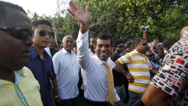 Former Maldives President Mohamed Nasheed, centre, waves to supporters after stepping out of the Indian High Commission in Male, Maldives, on Saturday