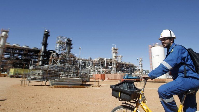 A British worker cycles past the Tigantourine gas plant in In Amenas, 1,600 km (1,000 miles) south-east of Algiers, on 31 January 2013
