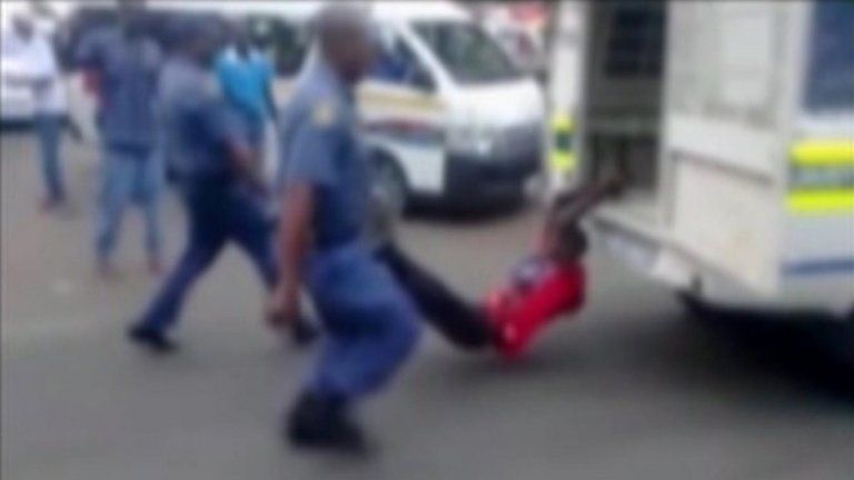 The man tied to a police van