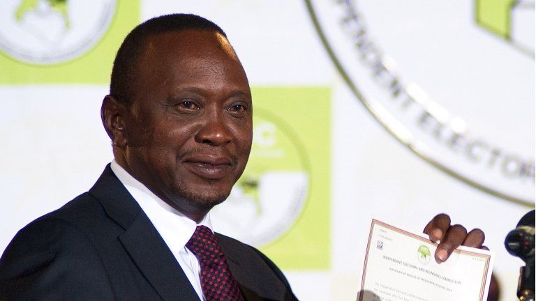 Uhuru Kenyatta shows a certificate confirming him as Kenya's new president in Nairobi, 9 March