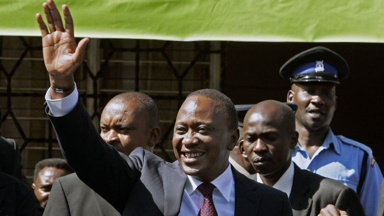 Uhuru Kenyatta (C) waves at the Bomas vote tallying centre, following his victory in Kenya"s national elections in Nairobi on March 9, 2013.