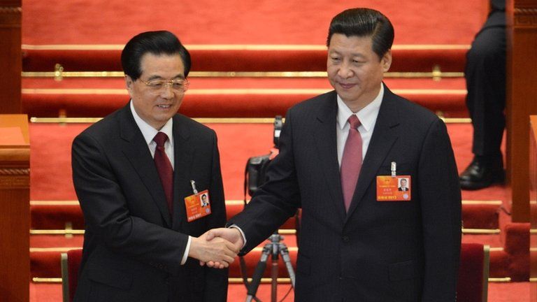 Newly-elected Chinese President Xi Jinping shakes hands with former president Hu Jintao at the Great Hall of the People in Beijing on 14 March 2013