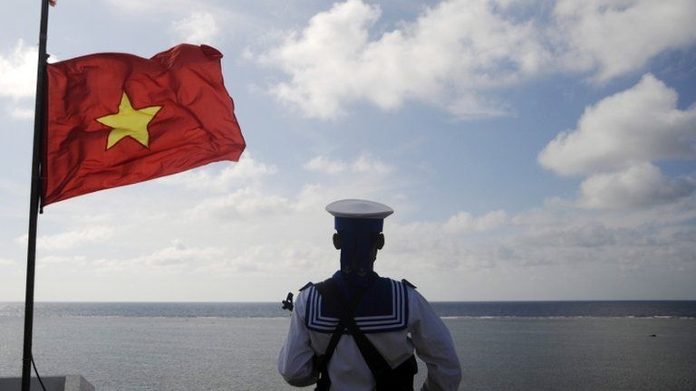 A Vietnamese naval soldier stands quard at Thuyen Chai island in the Spratly archipelago on 17 January 2013