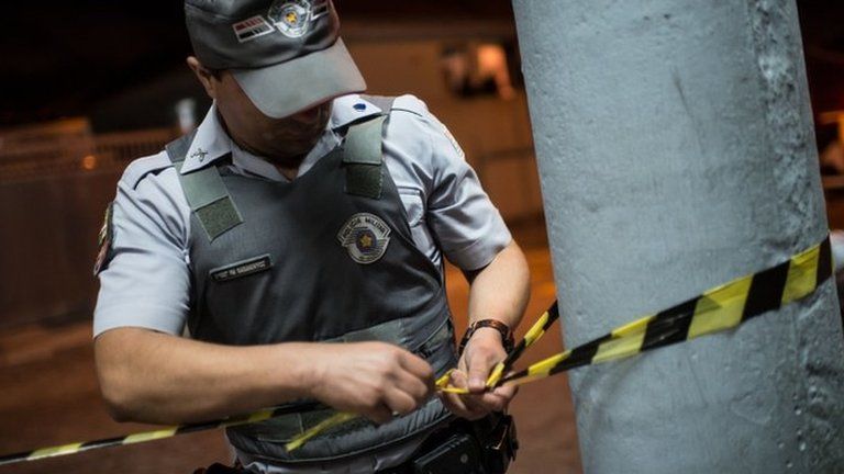 A police officer cordons off a crime scene in Sao Paulo. File photo