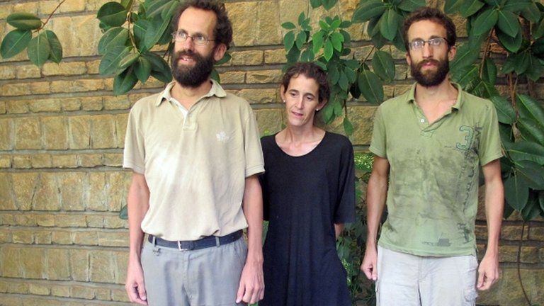 Former French hostages Tanguy Moulin-Fournier, his wife Albane and his brother Cyril pose at the French embassy in Yaounde on 19 April 2013