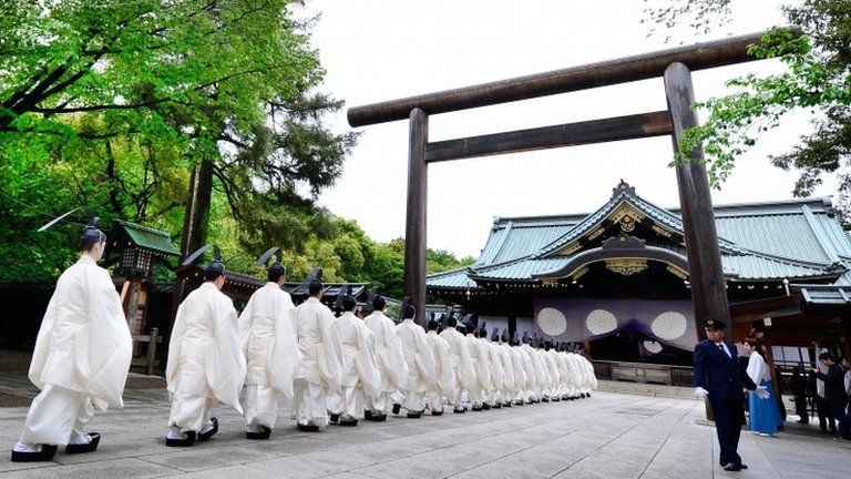 Shinto priests walk in line to the main shirine during the three-day annual spring festival at the Yasukuni Shrine in Tokyo on 21 April 2013