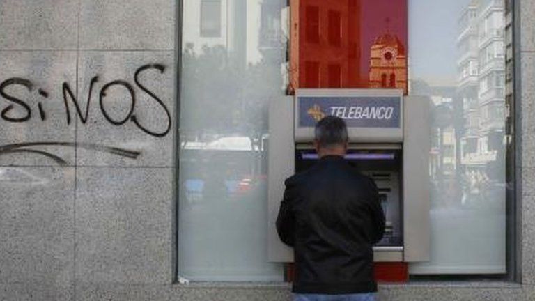 Bank with graffiti on wall