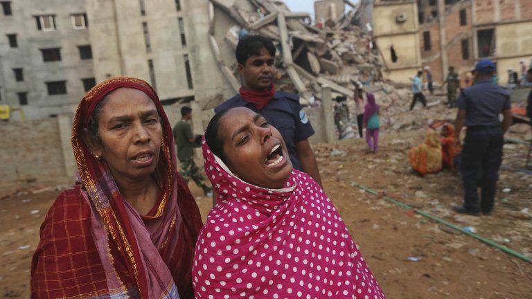 Bangladeshi women look for survivors after a building collapsed