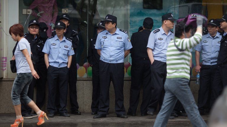Policemen stand at the site of the 8 May 2013 protest on 9 May 2013