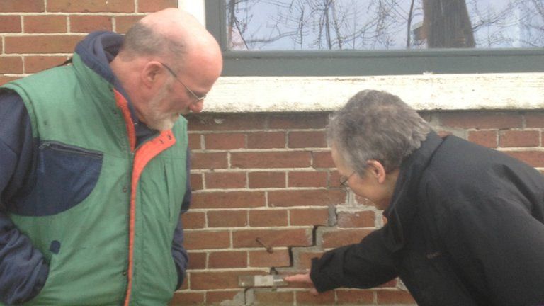 Klaas Koster and Jannette Schoorl point to a crack in the wall of their home in Middelstum, the Netherlands