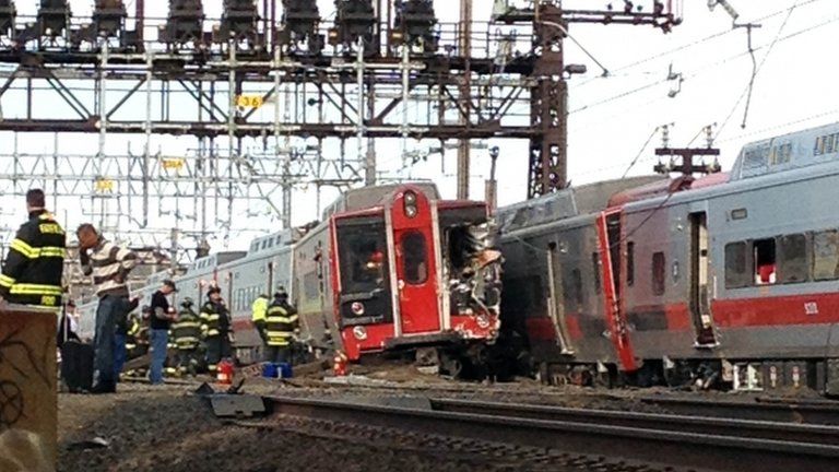 Emergency workers arrive the scene of a train collision in Fairfield, Connecticut, on 17 May 2013