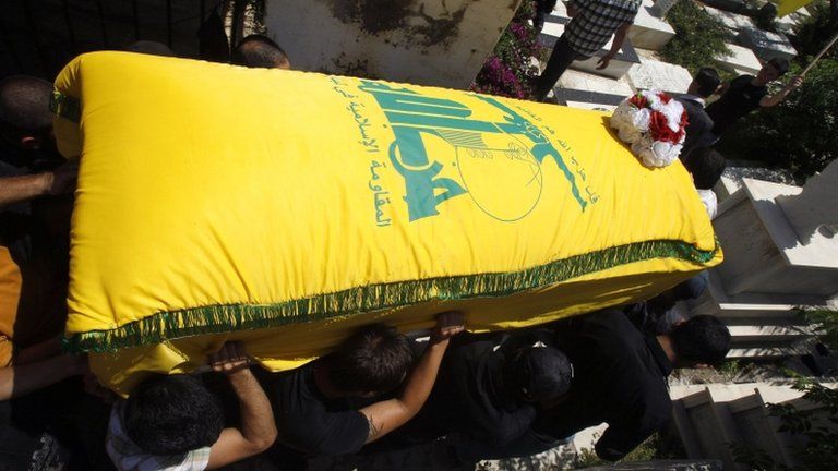 Men carry the coffin of a Hezbollah member killed in the Syrian town of Qusair, during his funeral in Sidon, southern Lebanon (22 May 2013)