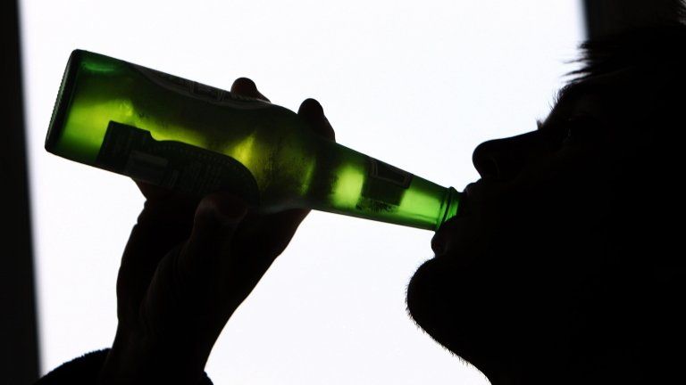 A man drinking beer from a bottle (file image)