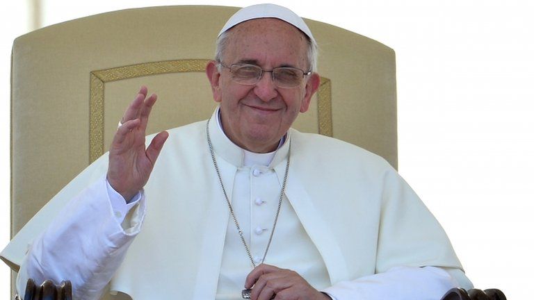 Pope Francis waves to people gathered in St Peter's Square at the Vatican on June 12, 2013