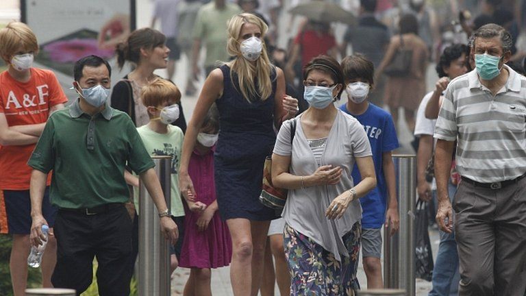People in Singapore wear masks against the smog. 21 June 2013
