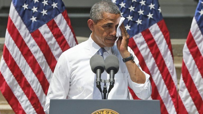 President Barack Obama wipes sweat from his face as he speaks about climate change at Georgetown University in Washington DC on 25 June 2013