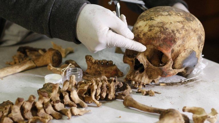 An archaeologist measures the remains of a women believed to be a member of the royalty of the Wari empire. Photo: 27 June 2013