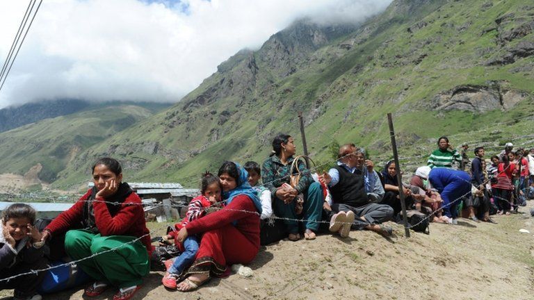 Stranded Indian pilgrims wait in line for their turn to be evacuated in an Indian Air Force helicopter at Badrinath on June 29, 2013