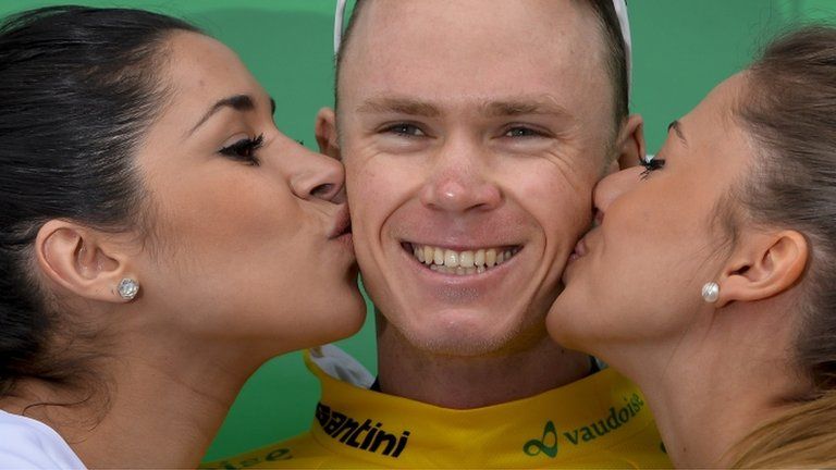 Cyclist Chris Froome being kissed by podium girls