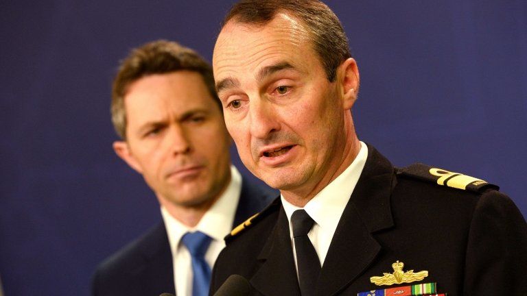 Commander of Border Protection Command, Rear Admiral David Johnston, Royal Australian Navy (right) and Home Affairs Minister Jason Clare (left), speak to the media during a press conference about the capsized boat in Sydney on 17 July 2013