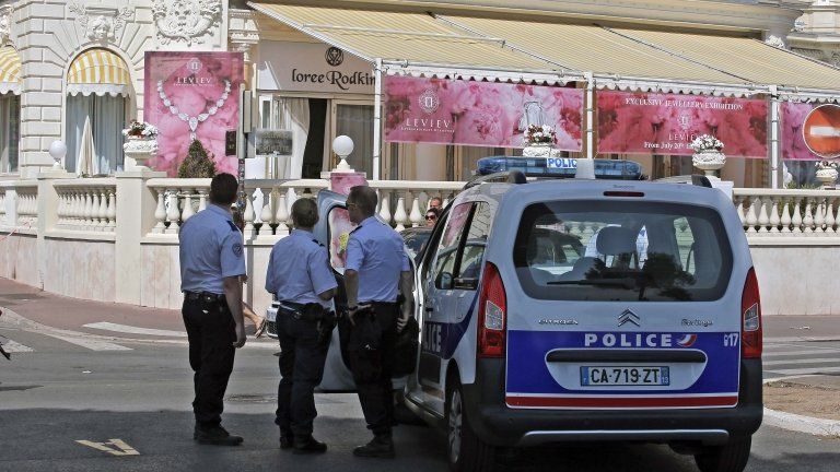 Police cars outside the Carlton Hotel in Cannes after a thief stole jewels worth about 40m euros