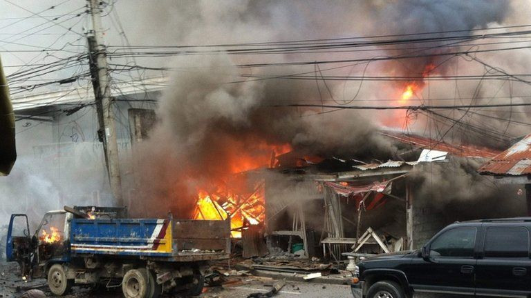 Houses are engulfed in fire after a bomb attack in the centre of Cotabato city in southern Philippines