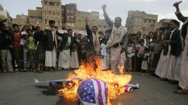 Protesters burn an effigy of a US aircraft after Friday prayers in Sanaa, Yemen, on 12 April 2013