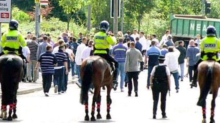 Football fans being dispersed by police after violence before a match