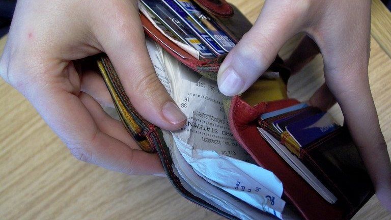 Woman opening wallet