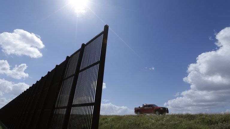 Cotton farmer Teofilo “Junior” Flores drives his truck along the U.S.-Mexico border fence that passes through his property in Brownsville, Texas 6 September 2012