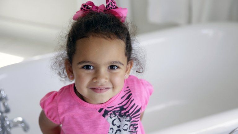 Veronica, the child at the centre of an international adoption dispute, smiles in a bathroom of the Cherokee Nation Jack Brown Center in Tahlequah, Oklahoma 6 August 2013