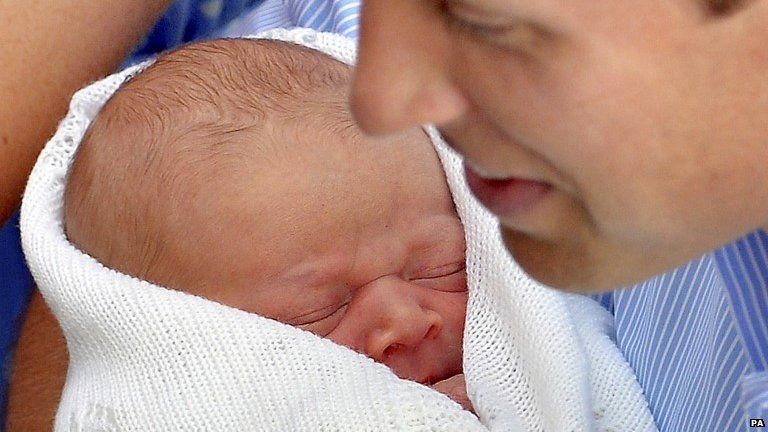 The Duke of Cambridge holds his son Prince George