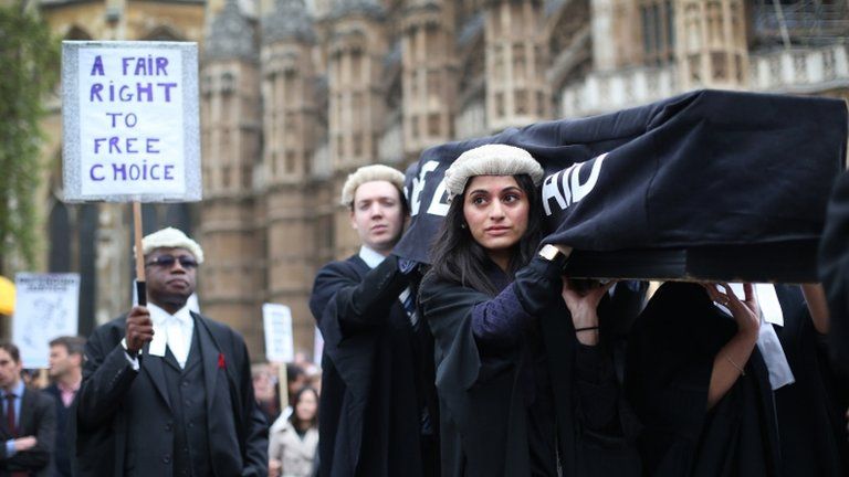 Protesters against legal aid cuts dressed as barristers outside Westminster
