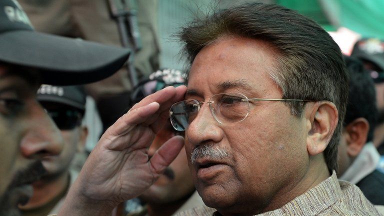 In this photograph taken on April 20, 2013, Former Pakistani president Pervez Musharraf (C) is escorted by soldiers as he salutes on his arrival at an anti-terrorism court in Islamabad.