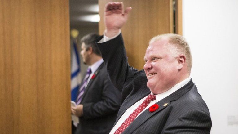 Toronto Mayor Rob Ford talks to a staff member at city hall on 6 November 2013