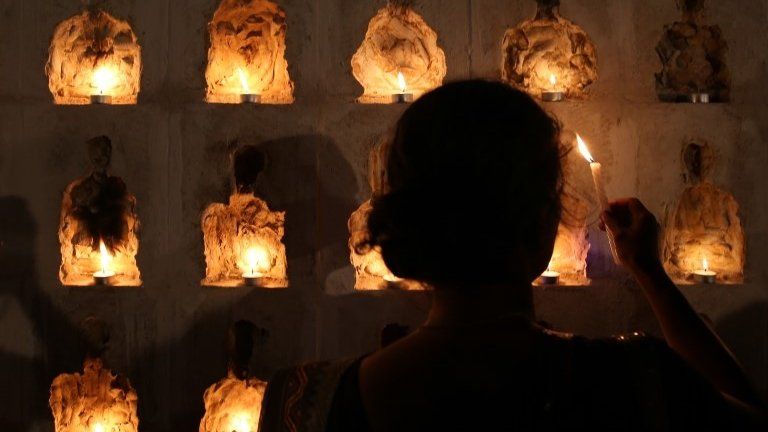 A woman belonging to the Tamil community lights a candle for those who died in Sri Lanka's civil war