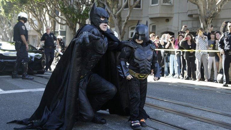 Miles Scott (right), walks with a man dressed as Batman in San Francisco, California, on 15 November 2013