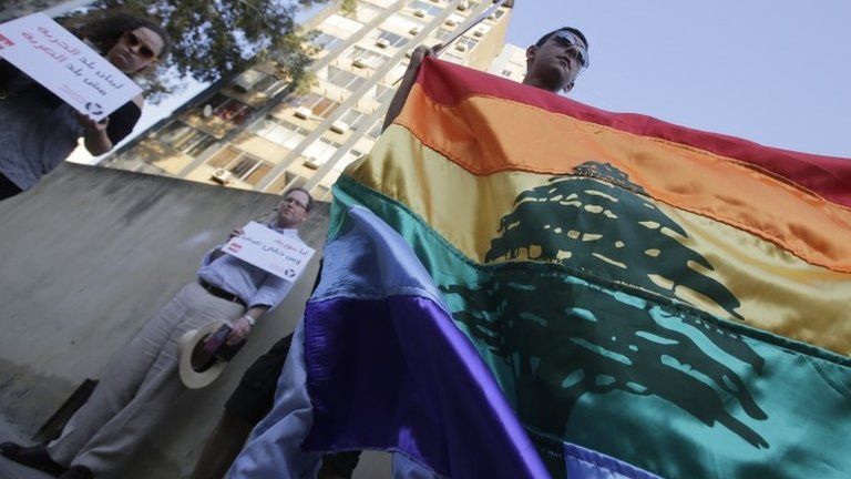 Human rights activists hold up a rainbow flag during an anti-homophobia rally in Beirut in April 2013
