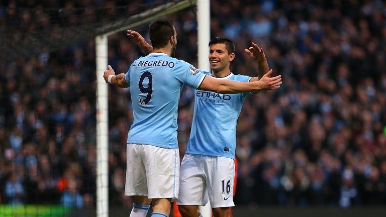 Alvaro Negredo and Sergio Aguero celebrate after Negredo scores City's fifth goal