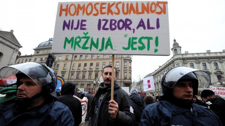 Protester holds sign reading "Homosexuality is not a choice, hate is a choice" in Zagreb