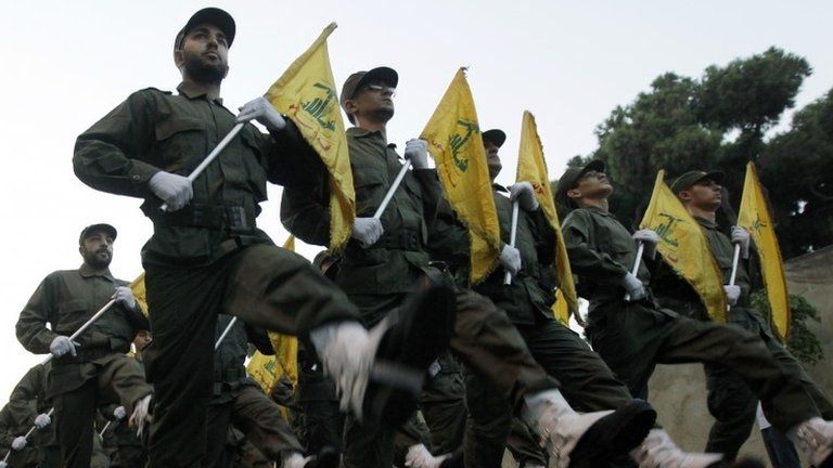 Hezbollah fighters parade through southern Beirut in 2010